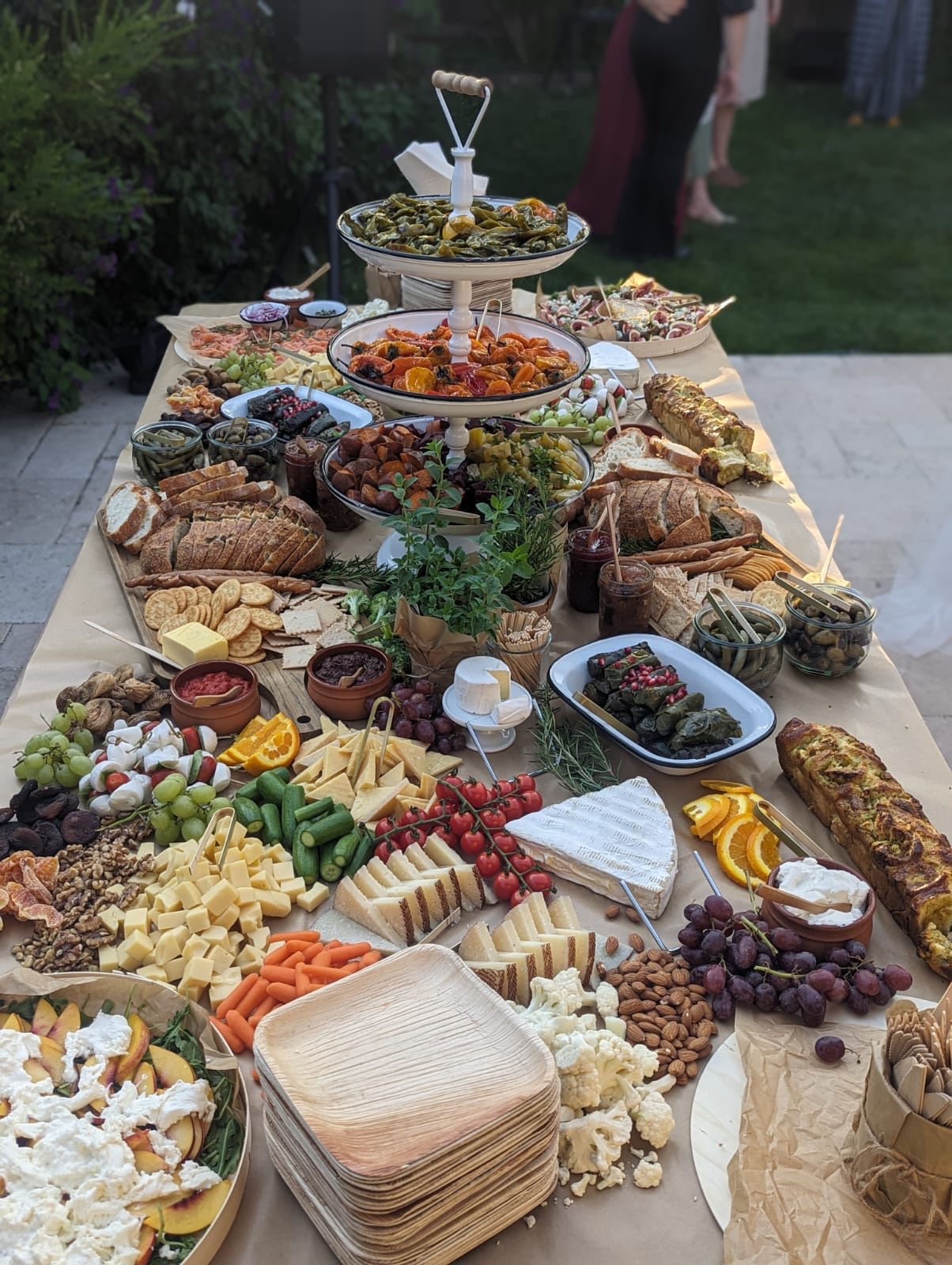 Generous grazing table with cheeses, charcuterie, fruit, breads, and dips
